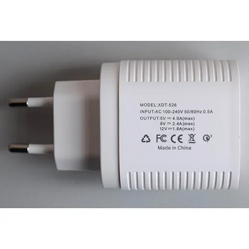 White plastic USB charger integrated with a European plug, featuring three USB Type-A ports and one USB Type-C port on the front interface.