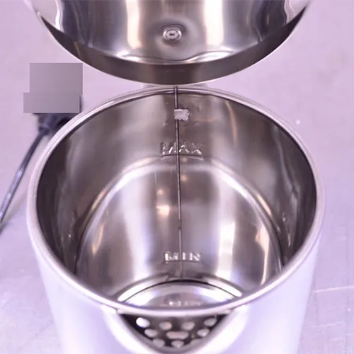 Electric kettle with attached wall plug.