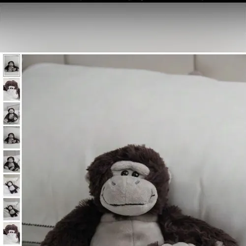 Grey soft toy in the shape of a monkey.