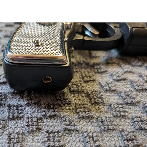 Novelty refillable gas lighter in the shape of a pistol, equipped with an additional electric-shock function and without a child-resistant safety mechanism, sold in bulk.