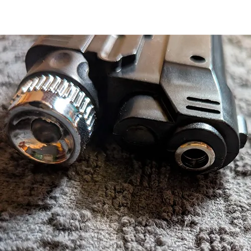 Novelty refillable gas lighter in the shape of a pistol, equipped with an additional electric-shock function and without a child-resistant safety mechanism, sold in bulk.