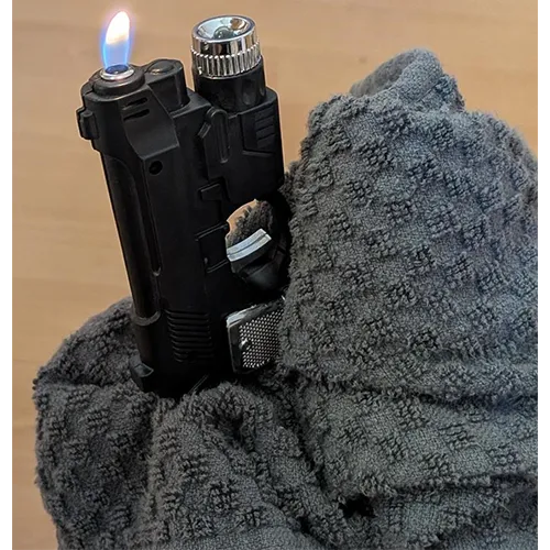 Novelty refillable gas lighter in the shape of a pistol, equipped with an additional electric-shock function and without a child-resistant safety mechanism, sold in bulk.