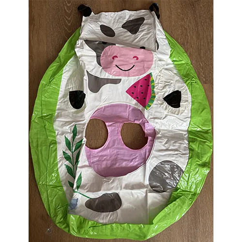 Green and white inflatable swim seat in the shape of a cow
