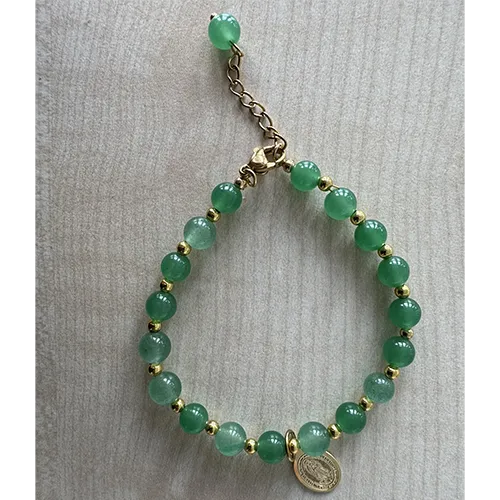 Rosary bracelet with green-coloured beads and a round metal pendant in between the beads, sold in bulk.