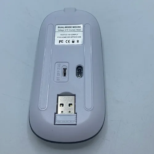 White wireless computer mouse with a USB charging cable.