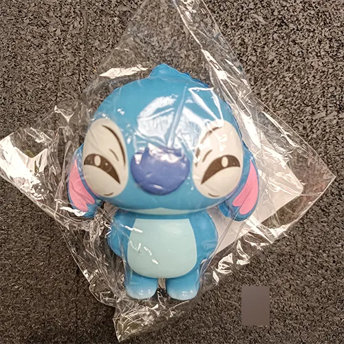 Plastic toy figurine in the shape of the character Stitch.