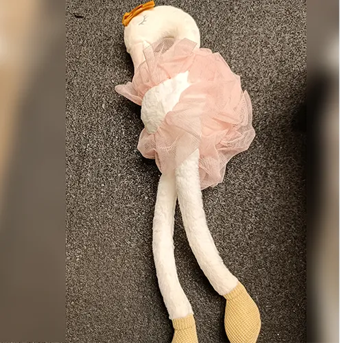 Plush toy in the shape of a swan in pink with a ballerina dress and golden crown.