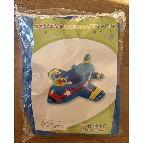 Blue inflatable swim seat in the shape of an aeroplane with a steering wheel