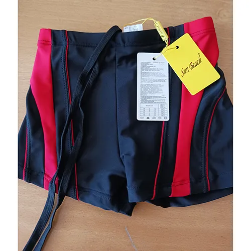 Swim briefs made of black and red knit fabric. It bears a textile drawstring with loose ends at the waistband.