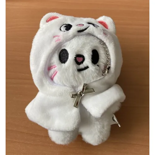 Soft toy keyring in the shape of a white cat with a metal chain, wearing a hooded cape with a small bow-shaped button.