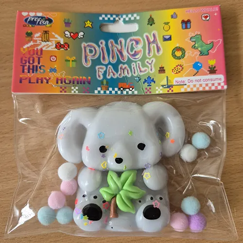 Squeezable toy set in the shape of a teddy bear, including balls, glitter, and tree-shaped details; made from a soft, stretchy material designed for hand-kneading, it returns to its original shape after being squeezed.