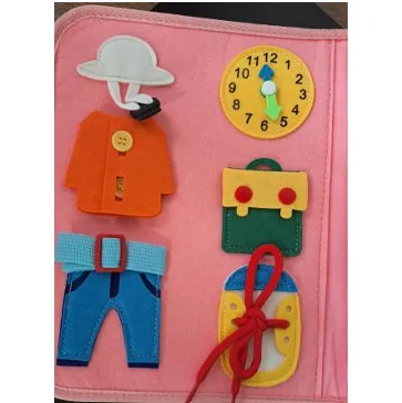 Pink busy board with stickers and accessories.